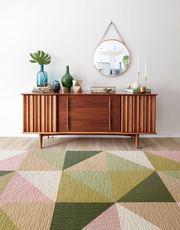 Lifestyle Image of Mid-Century Modern credenza with green, teal, and gold accents showing the New Signature Rug Garden Variety